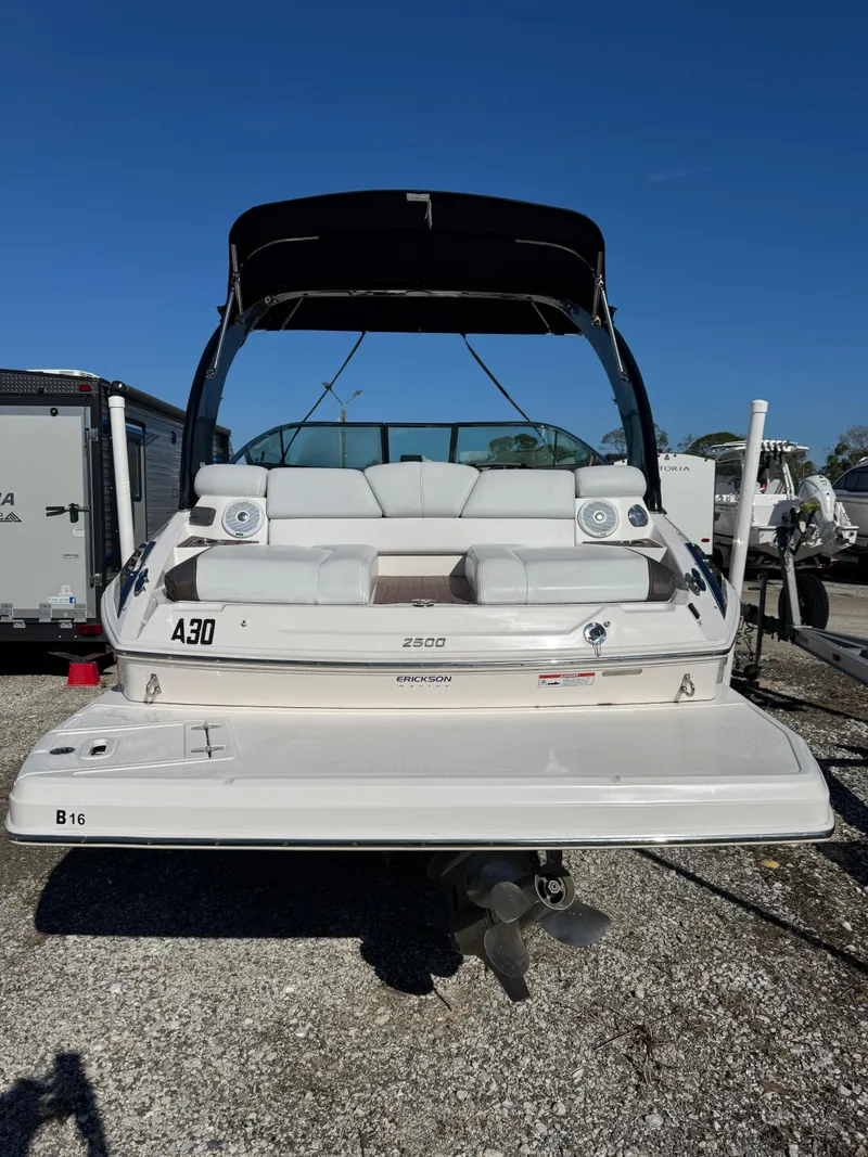 Slide: The Image of 2013 Regal 2500 Bowrider boat with swim platform, parked on gravel. - 15