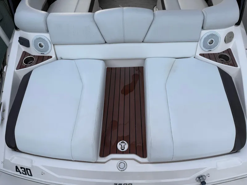 Slide: The Image of 2013 Regal 2500 Bowrider boat with white seating and wood accents. - 16