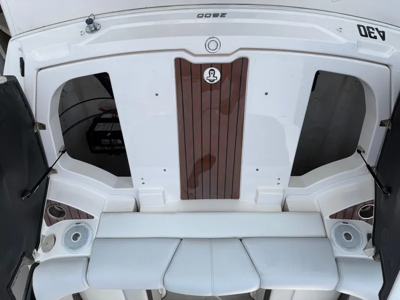 Slide: The Image of 2013 Regal 2500 Bowrider boat interior with white seating and wood accents. - 18