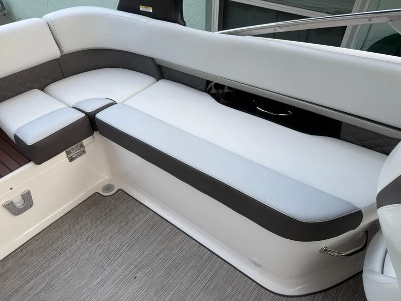 Slide: The Image of 2013 Regal 2500 Bowrider interior seating with white and gray upholstery. - 22