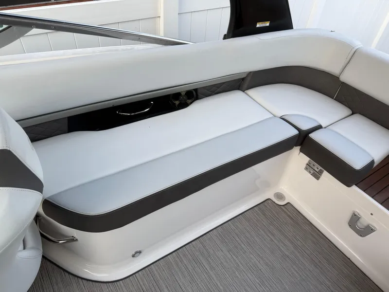 Slide: The Image of 2013 Regal 2500 Bowrider interior seating with white and gray upholstery. - 23