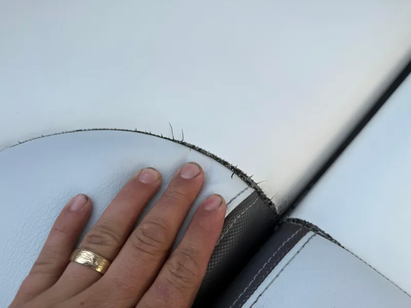 Slide: The Image of Close-up of worn upholstery on a 2013 Regal 2500 Bowrider boat seat. - 24