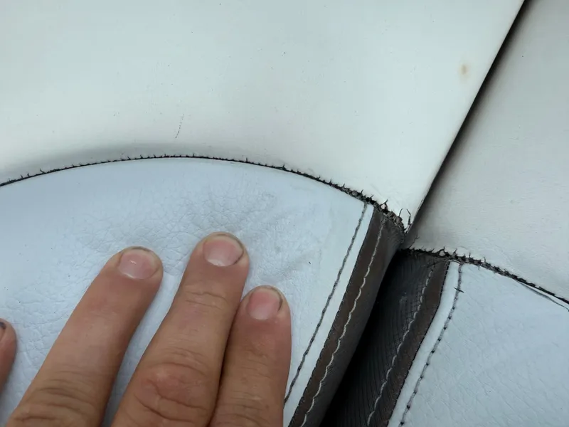 Slide: The Image of Close-up of worn upholstery on a 2013 Regal 2500 Bowrider boat seat. - 25