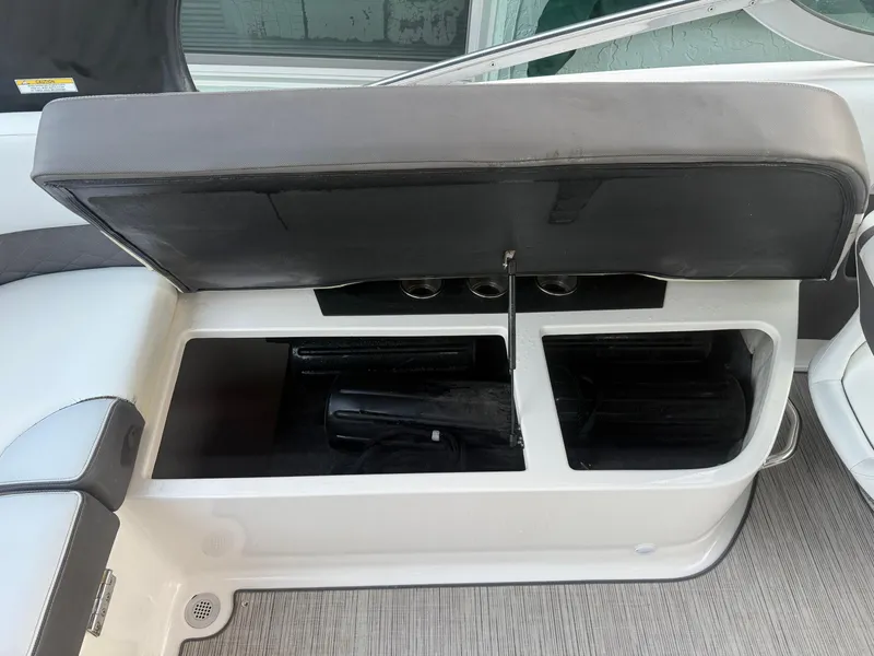 Slide: The Image of 2013 Regal 2500 Bowrider storage compartment with open seat revealing interior space. - 26