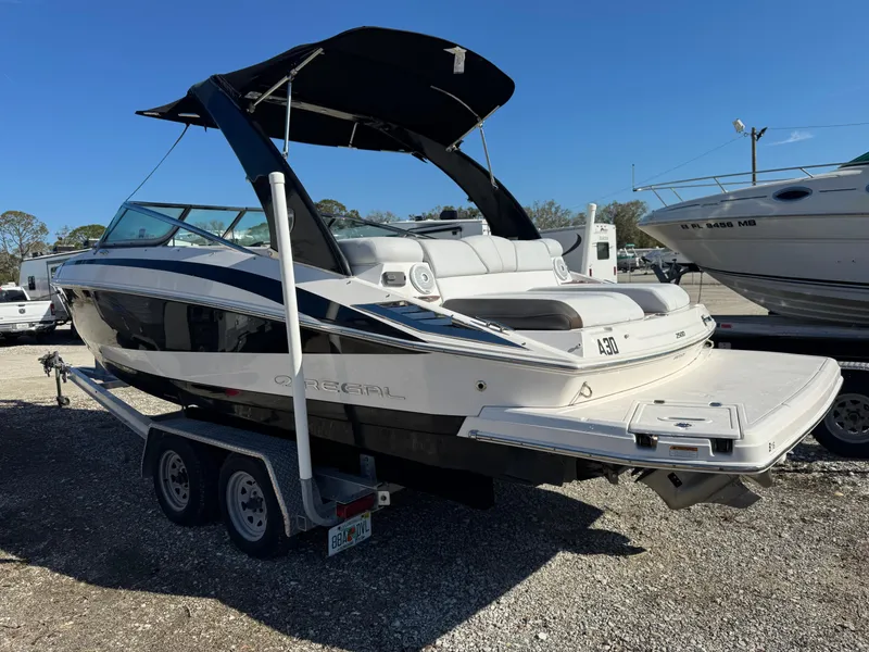 Slide: The Image of 2013 Regal 2500 Bowrider boat on trailer, featuring sleek design and spacious seating. - 3