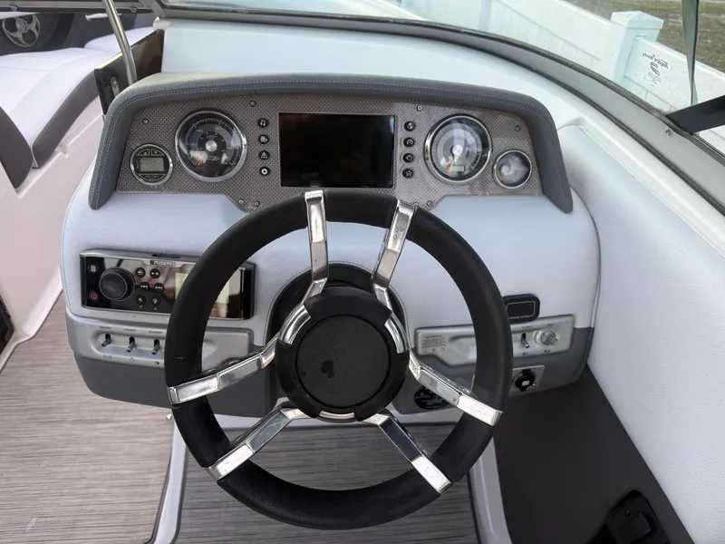 Slide: The Image of 2013 Regal 2500 Bowrider dashboard with steering wheel and control panel. - 31