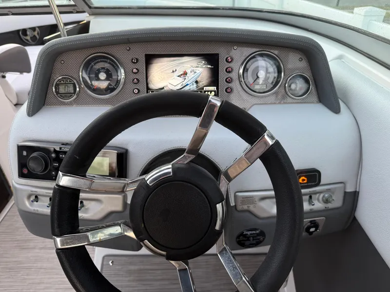 Slide: The Image of Steering wheel and dashboard of 2013 Regal 2500 Bowrider boat. - 32