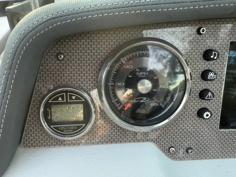 Slide: The Image of Dashboard of 2013 Regal 2500 Bowrider boat with speedometer and control buttons. - 34