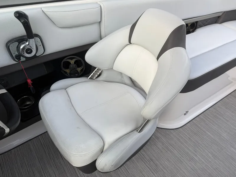 Slide: The Image of 2013 Regal 2500 Bowrider interior with white captain's chair and dashboard controls. - 43