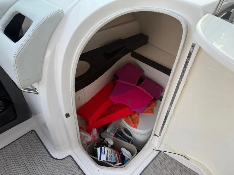 Slide: The Image of Storage compartment in a 2013 Regal 2500 Bowrider boat with life jackets and accessories. - 48