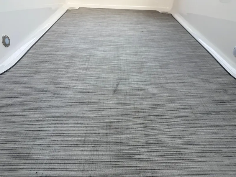 Slide: The Image of 2013 Regal 2500 Bowrider boat interior flooring, featuring a textured gray surface. - 49