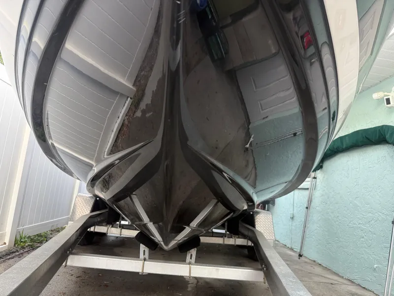 Slide: The Image of 2013 Regal 2500 Bowrider boat on trailer, viewed from below, showcasing sleek hull design. - 8