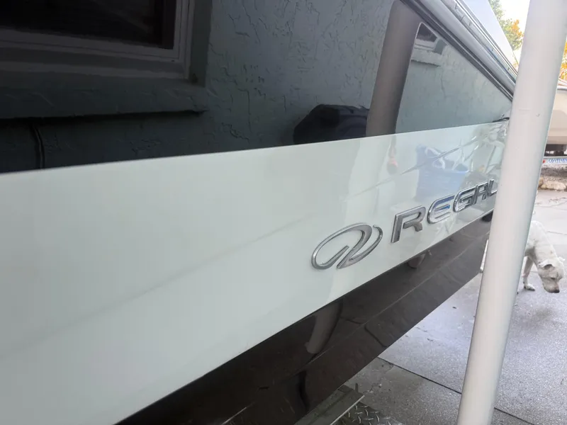 Slide: The Image of 2013 Regal 2500 Bowrider boat side view with logo visible. - 9