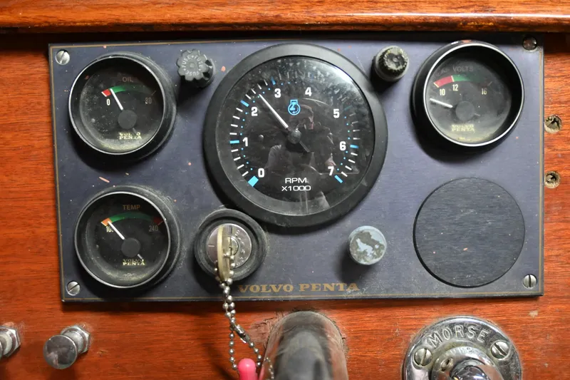 Slide: The Image of 1962 Lyman Utility boat dashboard with Volvo Penta gauges and Morse controls. - 3