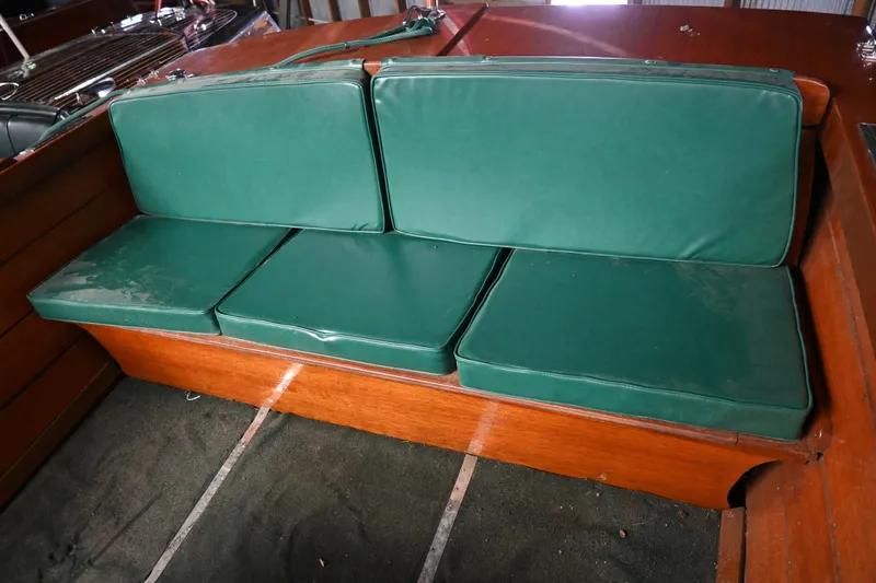 Slide: The Image of 1962 Lyman Utility boat with green cushioned seating. - 4