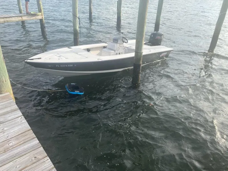 Slide: The Image of 2001 Hewes 19 boat docked on water. - 4