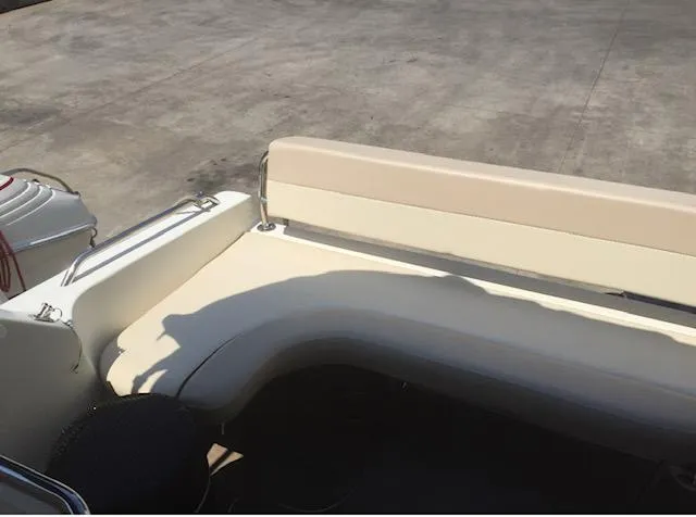 Slide: The Image of Interior seating of a 1998 Doral 2500 SC boat with beige upholstery. - 13