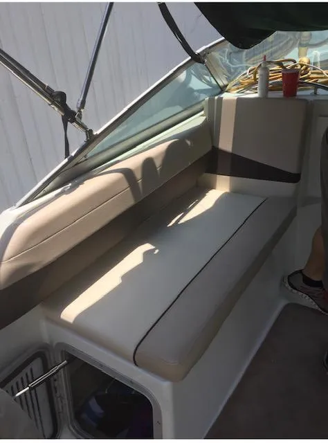 Slide: The Image of Interior seating of a 1998 Doral 2500 SC boat with beige cushions. - 15