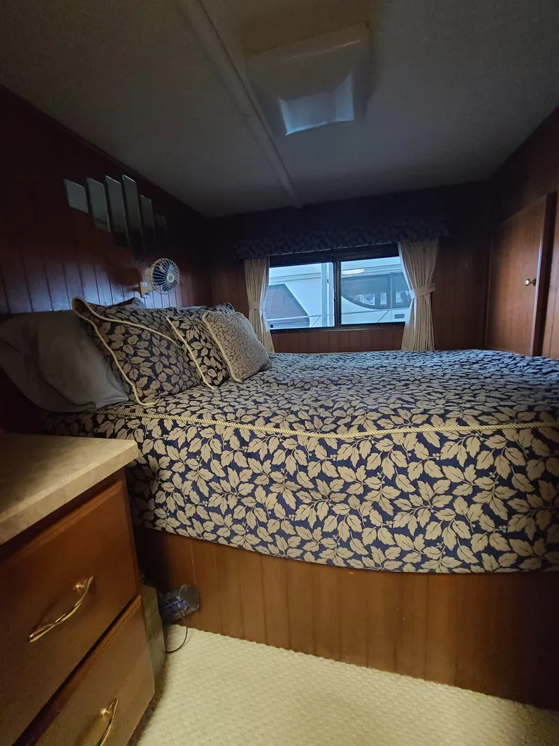 Slide: The Image of Cozy bedroom in a 2003 Monticello River Yacht with floral bedding. - 15