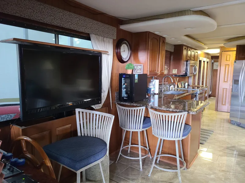 Slide: The Image of Luxurious interior of a 2003 Monticello River Yacht with kitchen and seating area. - 18