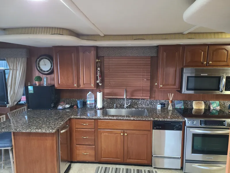 Slide: The Image of 2003 Monticello River Yacht kitchen with granite countertops and stainless steel appliances. - 19