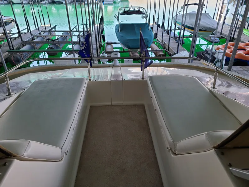 Slide: The Image of 2003 Monticello River Yacht interior with docked boats in the background. - 24