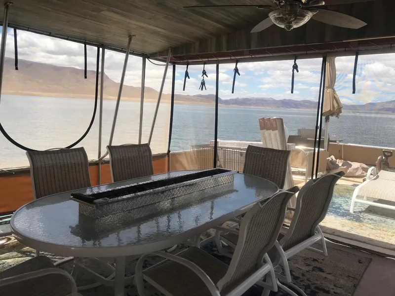 Slide: The Image of 2003 Monticello River Yacht interior with dining area and scenic lake view. - 27