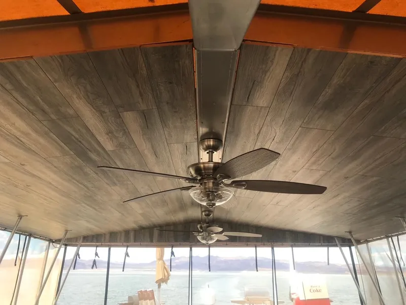 Slide: The Image of Ceiling fan on 2003 Monticello River Yacht with wooden ceiling and lake view. - 28