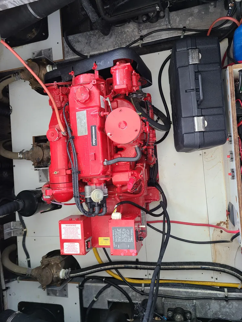 Slide: The Image of Engine compartment of a 2003 Monticello River Yacht with a red engine. - 29