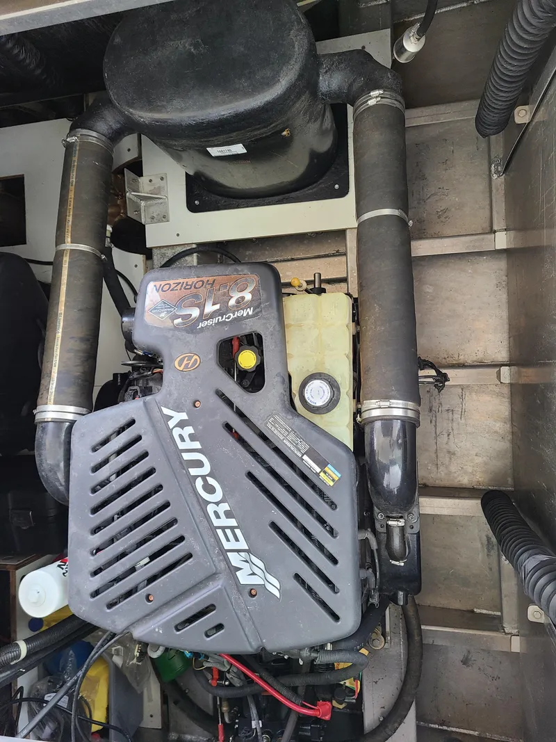 Slide: The Image of 2003 Monticello River Yacht engine compartment with Mercury engine. - 30