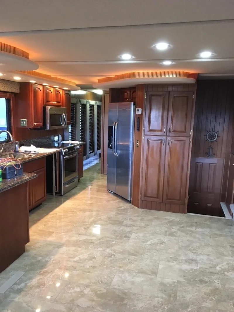 Slide: The Image of Interior of a 2003 Monticello River Yacht with modern kitchen and wooden cabinetry. - 32