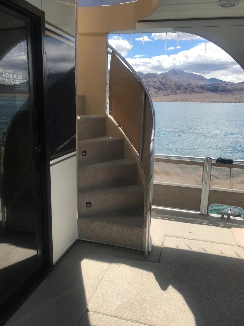 Slide: The Image of 2003 Monticello River Yacht interior with staircase and scenic lake view. - 33