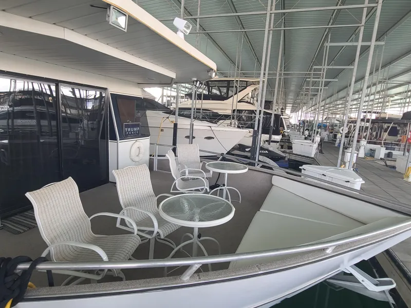 Slide: The Image of 2003 Monticello River Yacht docked with outdoor seating area and glass tables. - 4