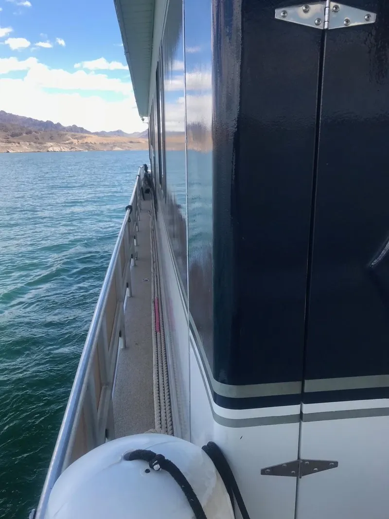 Slide: The Image of Side view of a 2003 Monticello River Yacht on a lake. - 7