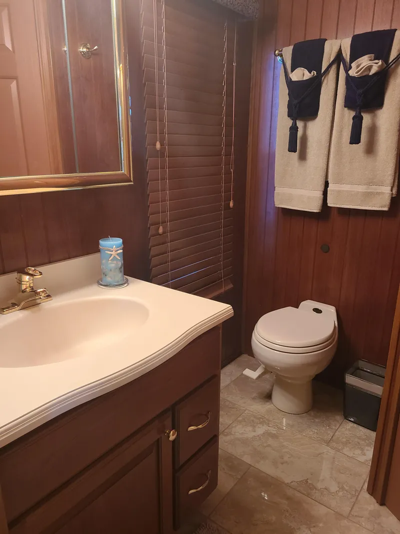 Slide: The Image of 2003 Monticello River Yacht bathroom with wooden decor and modern amenities. - 8