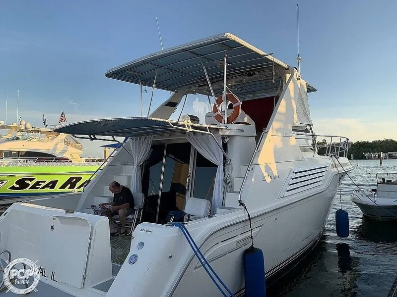 Slide: The Image of 1994 Cruisers Yachts Express Bridge docked at marina, rear view. - 1
