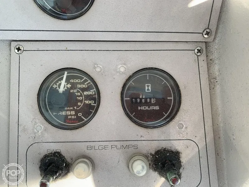 Slide: The Image of 1994 Cruisers Yachts Express Bridge dashboard with gauges and bilge pump switches. - 18