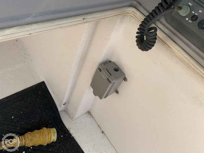 Slide: The Image of 1994 Cruisers Yachts Express Bridge interior with electrical outlet and coiled cable. - 25