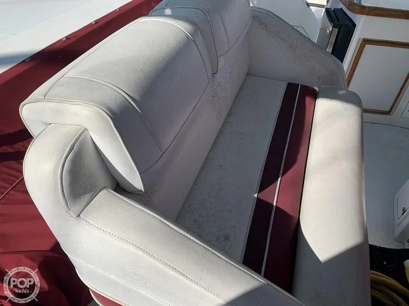Slide: The Image of 1994 Cruisers Yachts Express Bridge interior seating with red and white upholstery. - 3