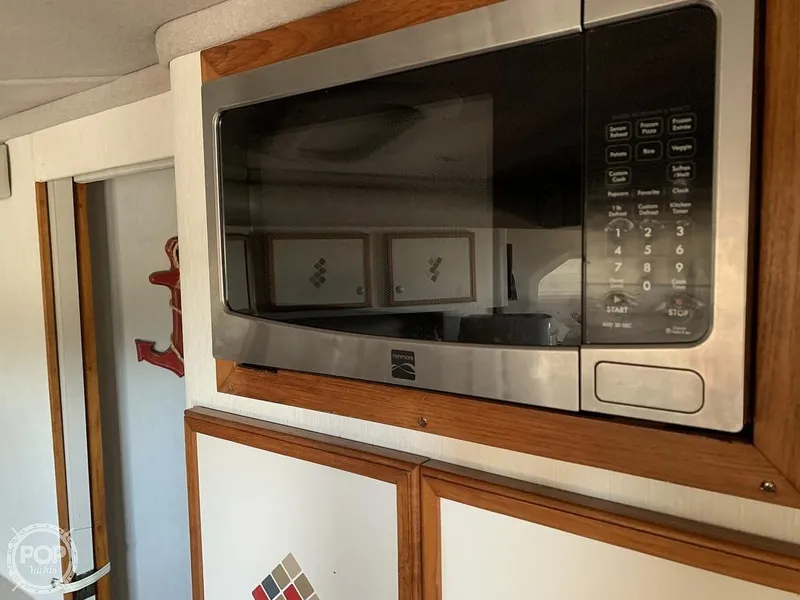 Slide: The Image of Microwave in the kitchen area of a 1994 Cruisers Yachts Express Bridge. - 31