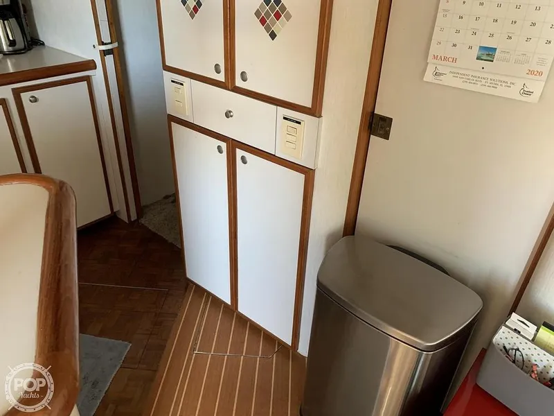 Slide: The Image of 1994 Cruisers Yachts Express Bridge interior with cabinets and stainless steel trash can. - 33