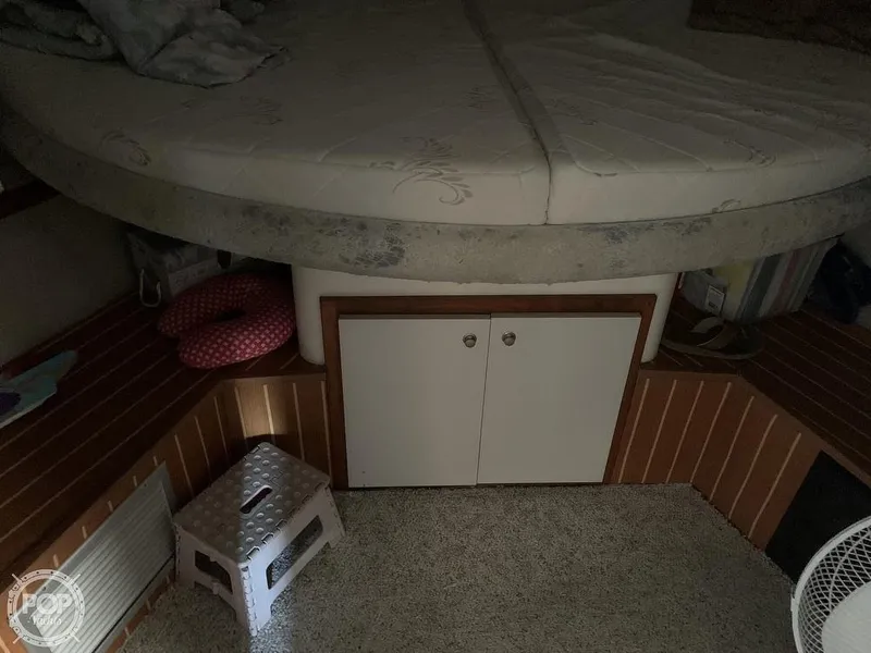 Slide: The Image of 1994 Cruisers Yachts Express Bridge interior cabin with bed and storage compartments. - 37