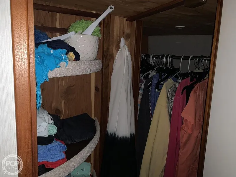 Slide: The Image of Closet storage in 1994 Cruisers Yachts Express Bridge with hanging clothes and shelves. - 38