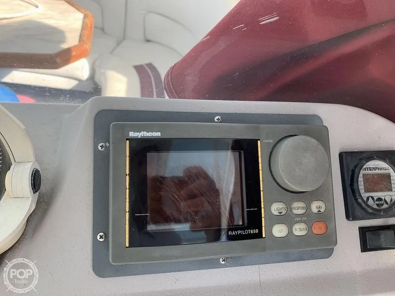 Slide: The Image of 1994 Cruisers Yachts Express Bridge dashboard with Raytheon navigation system. - 10