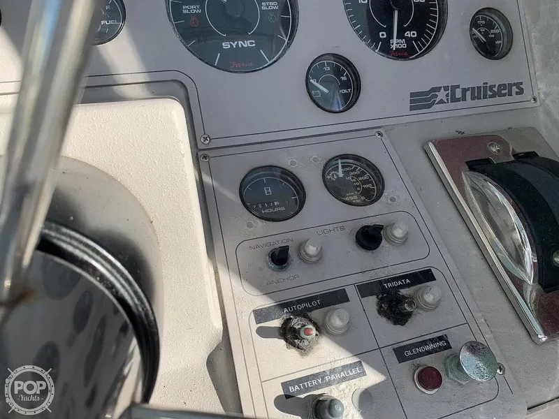 Slide: The Image of 1994 Cruisers Yachts Express Bridge control panel with gauges and switches. - 15