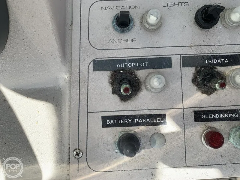 Slide: The Image of 1994 Cruisers Yachts Express Bridge control panel with autopilot and battery parallel switches. - 17