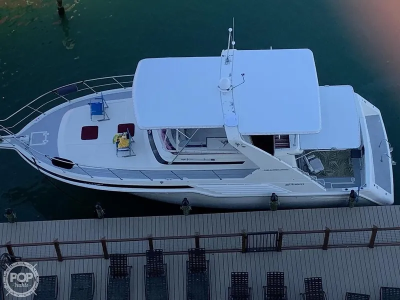 Slide: The Image of 1994 Cruisers Yachts Express Bridge docked at a marina, top view. - 2