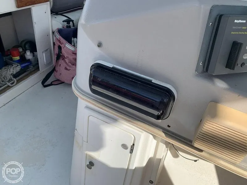 Slide: The Image of 1994 Cruisers Yachts Express Bridge dashboard with storage compartments and navigation equipment. - 24