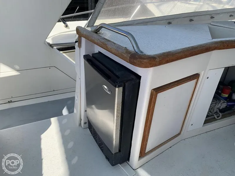 Slide: The Image of 1994 Cruisers Yachts Express Bridge with mini fridge and storage compartments. - 26