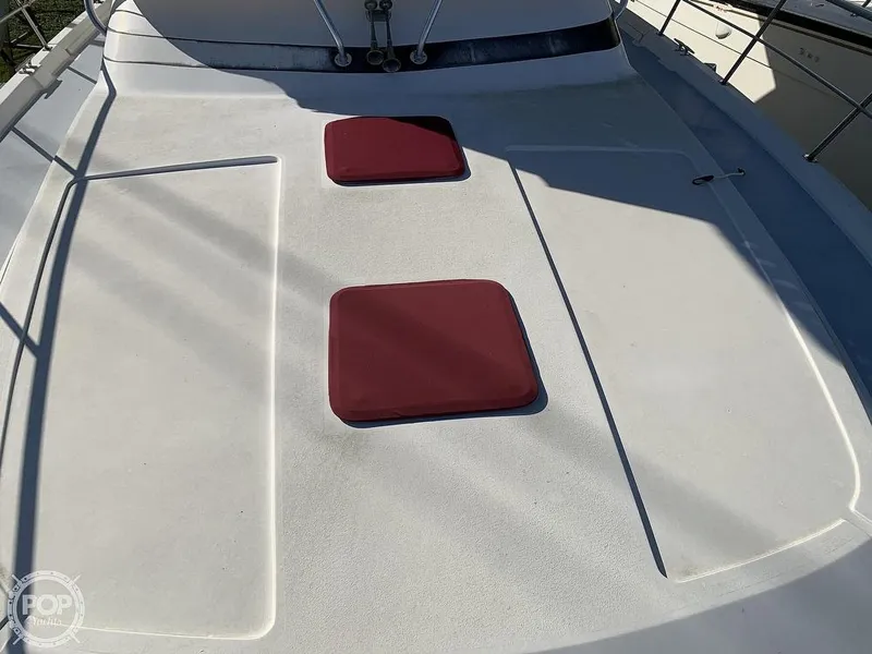 Slide: The Image of 1994 Cruisers Yachts Express Bridge deck with red cushions. - 30